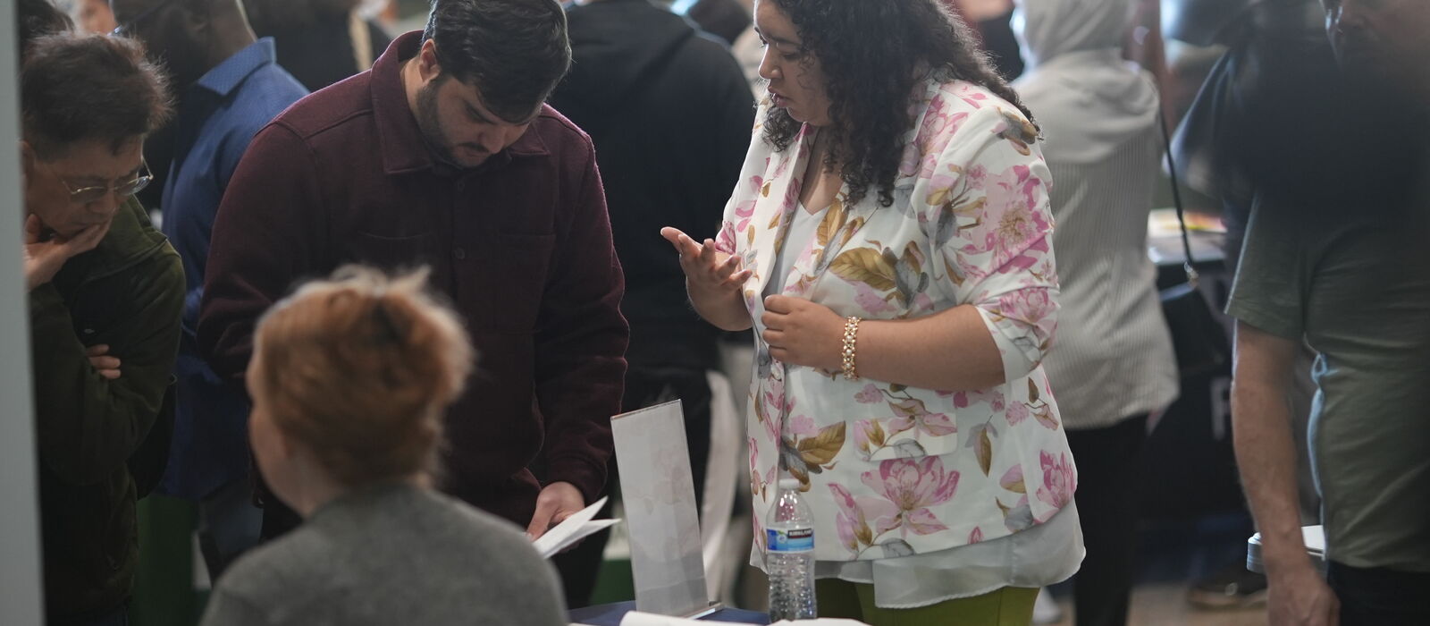 Attendees and staff talking across tables at an INCIGHT event.