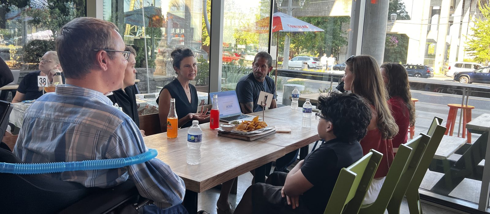 INCIGHT scholars and staff talking around a table over lunch.